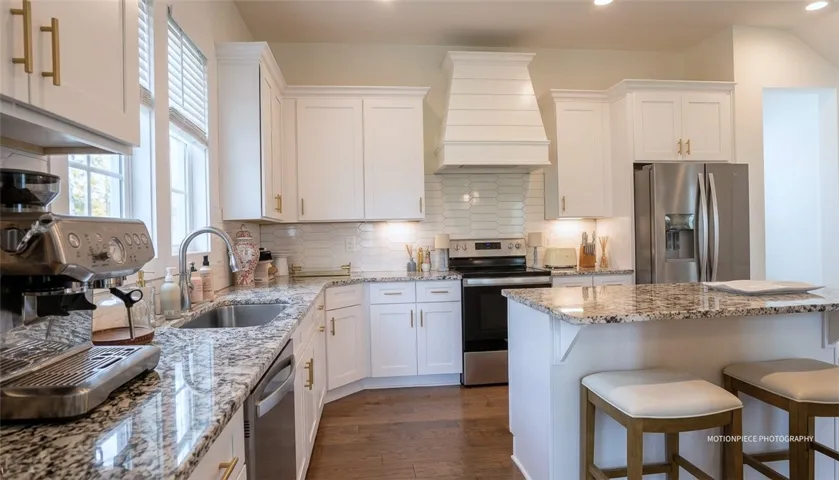Granite counters and stainless appliances define this modern, well-appointed kitchen.