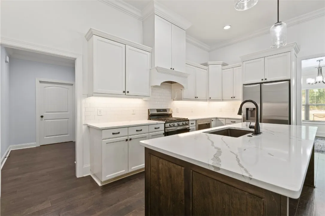 Culinary dreams come alive in this well-appointed kitchen featuring a large central island and gleaming appliances.