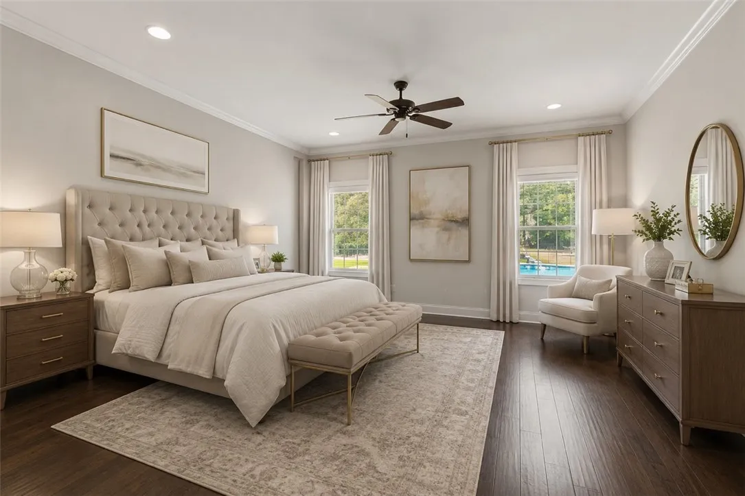 An inviting sleeping space with hardwood flooring and bright windows framing outdoor tranquility.
