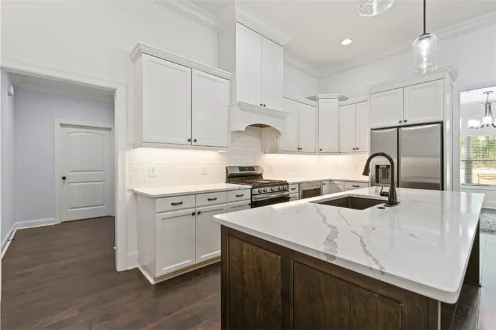 Culinary dreams come alive in this well-appointed kitchen featuring a large central island and gleaming appliances.