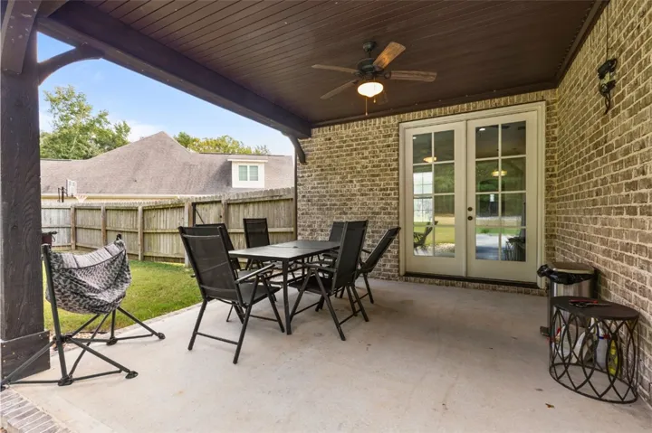 An inviting covered patio offers a comfortable outdoor dining area, perfect for relaxed entertaining.