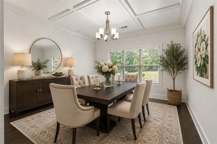 Coffered ceilings crown this elegant dining space with a broad view of the natural landscape.