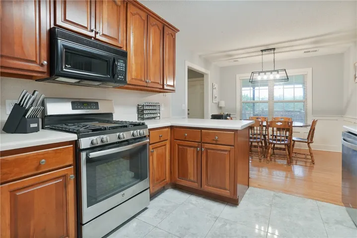 Culinary creations come to life in this kitchen, complete with natural wood cabinetry and stainless steel appliances.