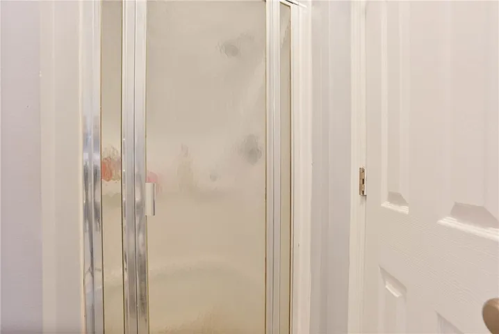 Step into a refreshing shower featuring privacy-frosted doors and a sleek aluminum frame.