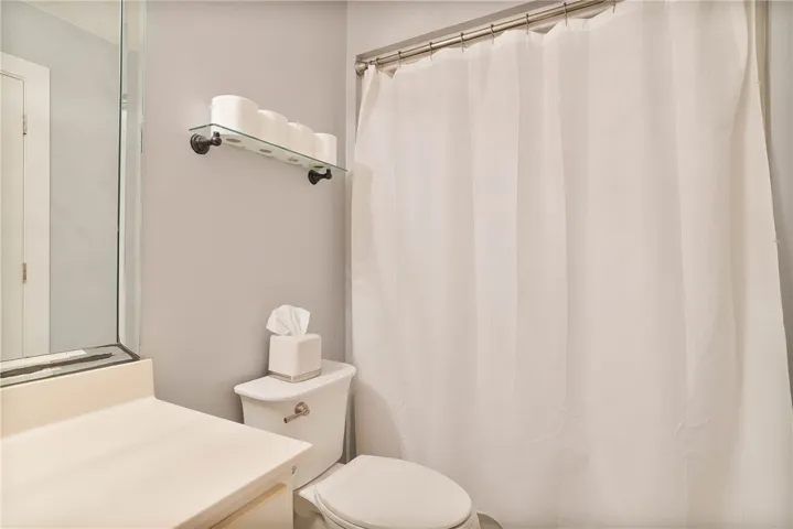 Functional full bathroom featuring a tub with a privacy shower curtain.