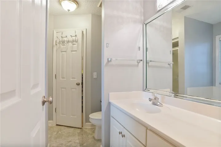 Sleek vanity with a large mirror and ample counter space defines this modern bathroom.
