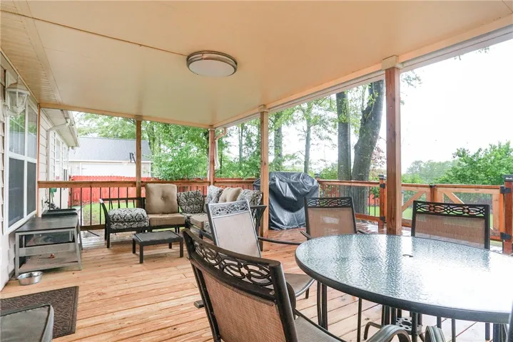 A welcoming covered deck offers ample space for outdoor entertaining and relaxation.