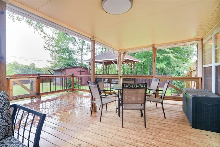 A spacious covered deck offers a private outdoor retreat with ample room for entertaining and relaxation.