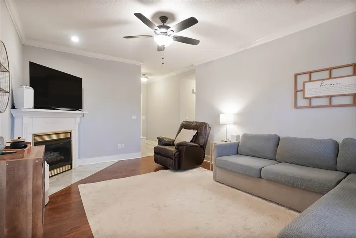 A well-appointed living area features a charming fireplace with a mantle and durable flooring throughout.