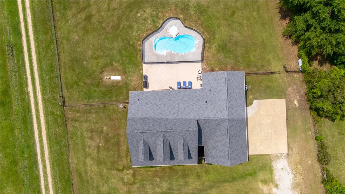 An aerial perspective reveals a private pool with ample patio space adjoining the residence.