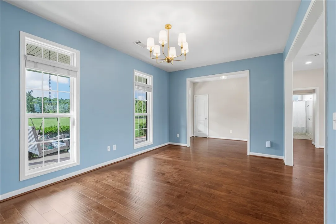 Hardwood floors and ample windows provide an airy and well-lit interior, perfect for any living arrangement.