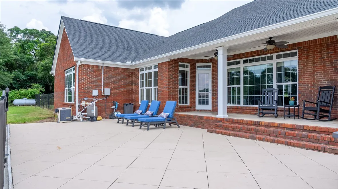 A spacious brick patio provides ample room for outdoor enjoyment and poolside lounging.