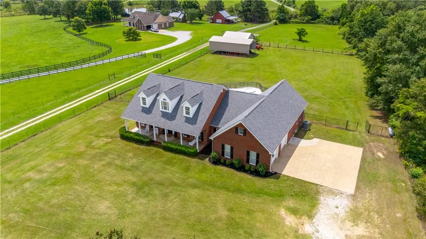 Discover a charming brick residence nestled on a generous lot, offering peaceful, verdant views.