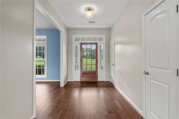 A welcoming entryway with rich hardwood flooring leads into an inviting interior.