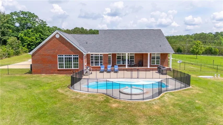 A spacious brick residence with a private fenced pool and spa for relaxed outdoor living.