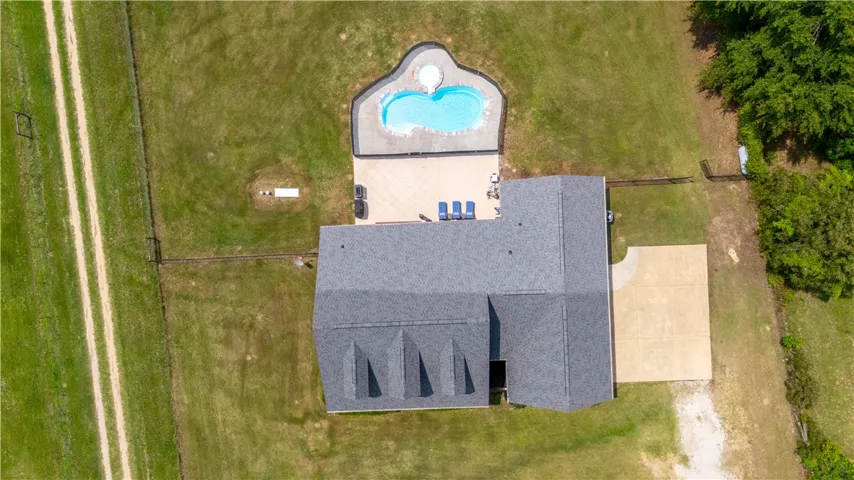 An aerial perspective reveals a private pool with ample patio space adjoining the residence.