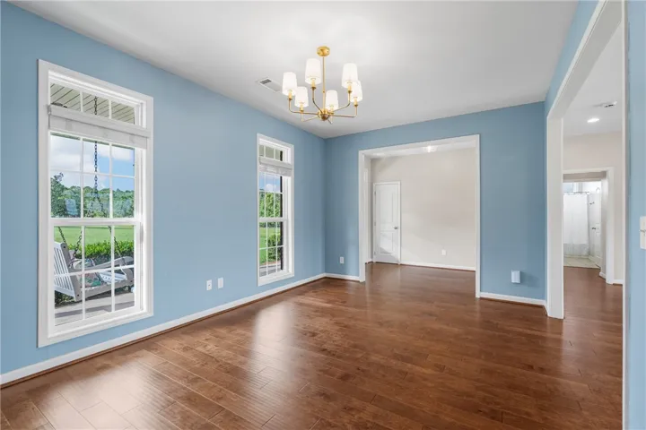 Hardwood floors and ample windows provide an airy and well-lit interior, perfect for any living arrangement.