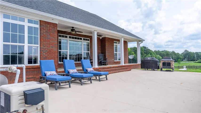 A spacious brick patio with a large covered porch creates an ideal setting for outdoor gatherings.