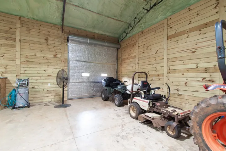 Secure storage for all your equipment with robust wooden walls and a roll-up door.