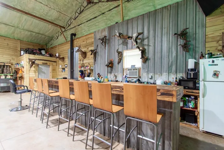 Gather around the bar, perfect for entertaining in this unique space.