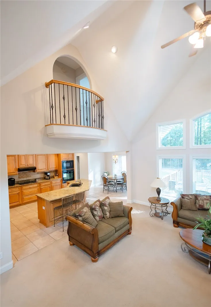 Voluminous vaulted ceilings elevate this open-concept great room, perfect for entertaining.