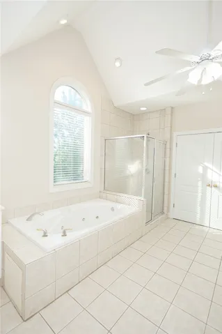 Indulge in a primary bathroom featuring a spacious jetted tub and a walk-in shower.