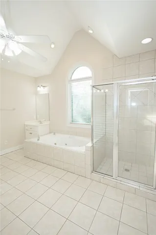 Indulge in relaxation with this inviting soaking tub and spacious walk-in shower.