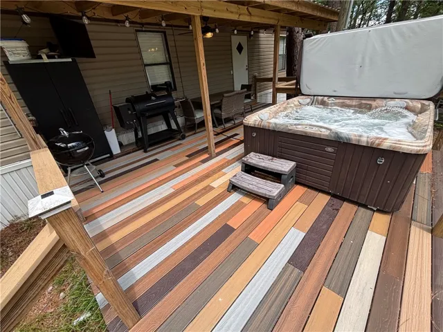 An inviting deck offers a bubbling spa and ample space for outdoor enjoyment.