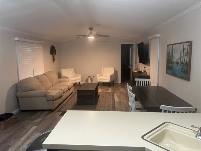 An open floorplan seamlessly connects the living and dining areas, illuminated by recessed lighting.