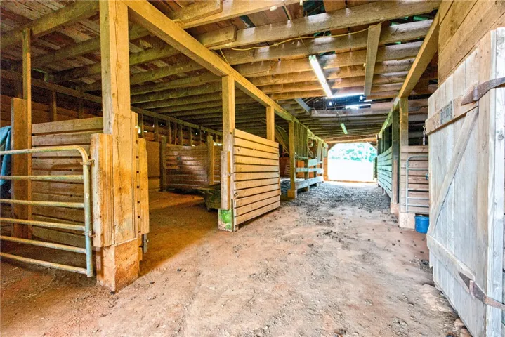 A rustic barn featuring sturdy wooden construction and practical stalls for equestrian needs.