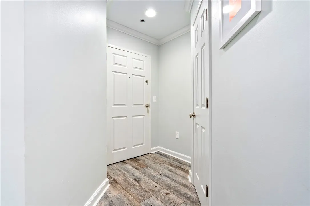 Step inside this inviting entry hall featuring elegant crown molding and rich hardwood flooring.