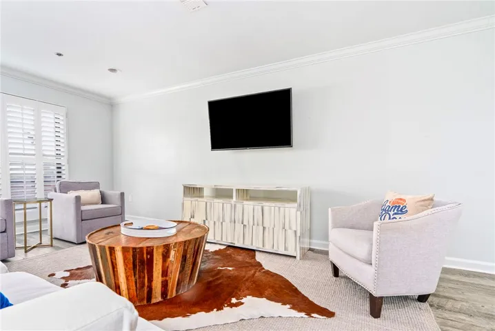 Recessed lighting illuminates this inviting living space, creating a cozy atmosphere.