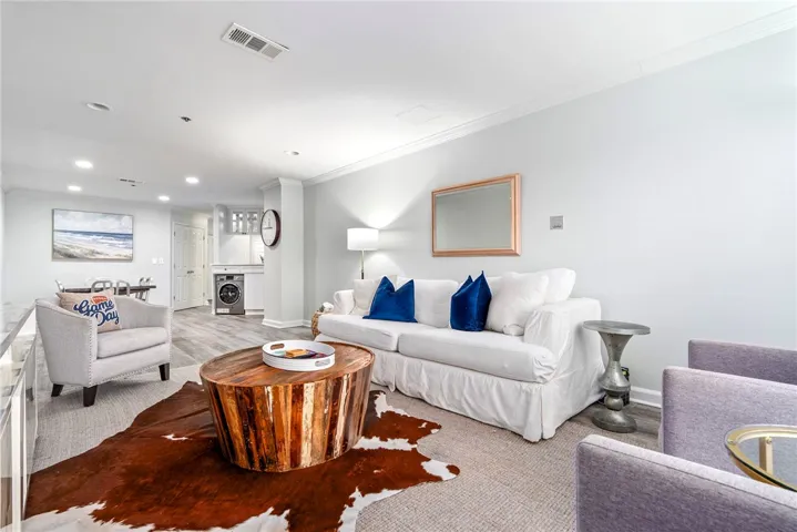 Recessed lighting illuminates this inviting living space, complementing a modern aesthetic.