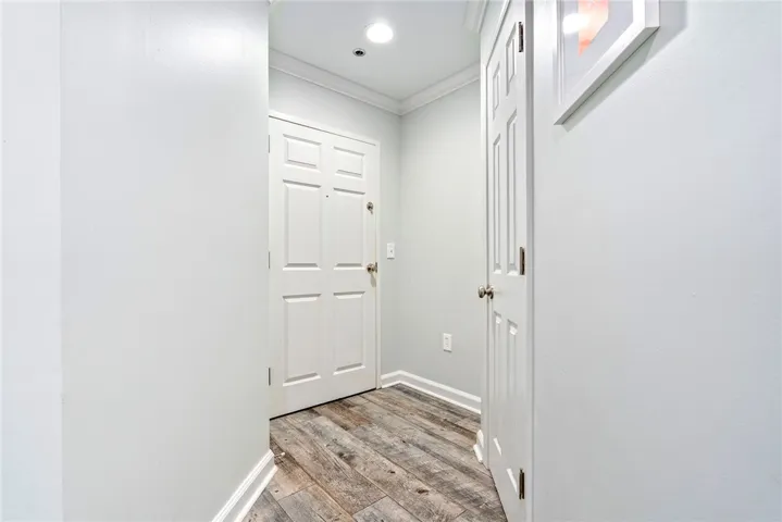 Step inside this inviting entry hall featuring elegant crown molding and rich hardwood flooring.