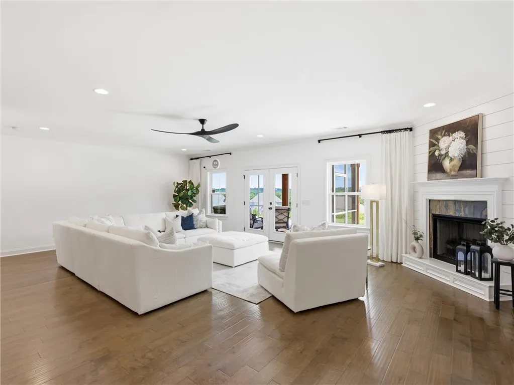 Warm hardwood floors and a cozy fireplace create a welcoming ambiance in this generous living area.