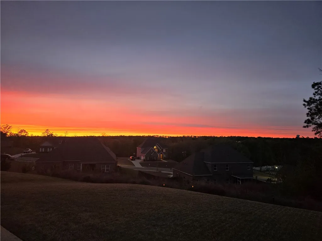 Golden hues paint the horizon, illuminating an inviting residential setting.