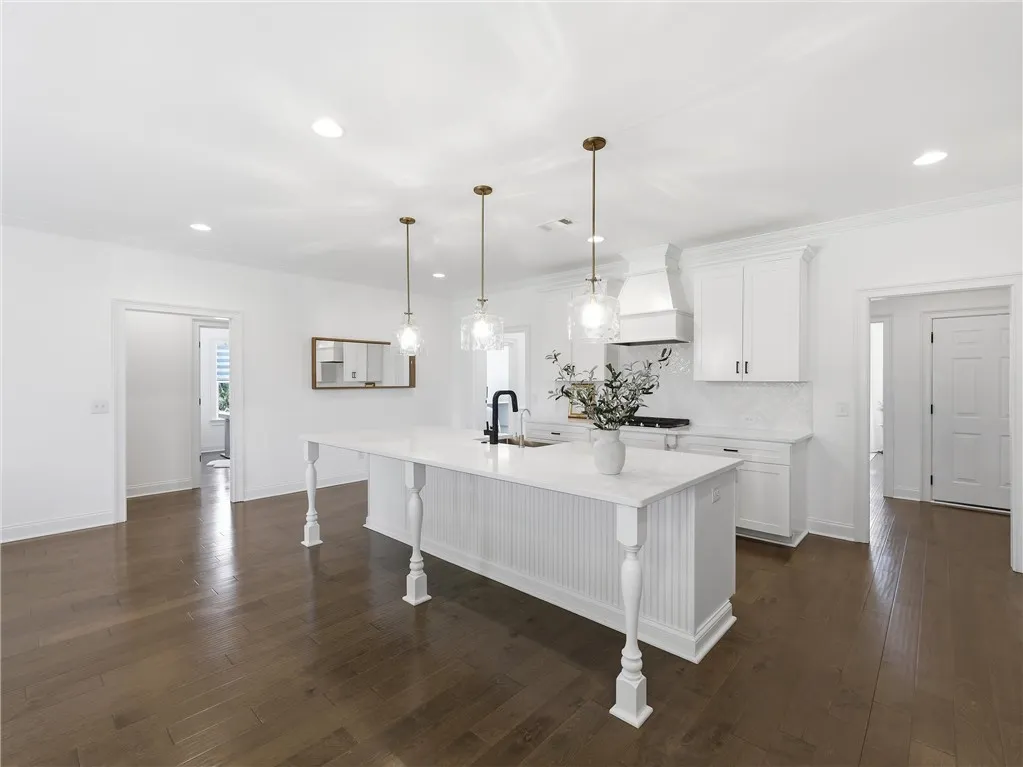 A spacious kitchen features a grand center island, ideal for entertaining and culinary creation.