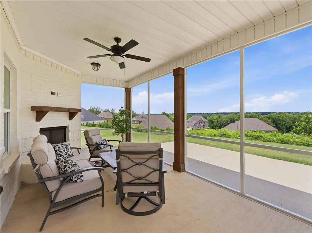 An inviting screened porch provides a peaceful outdoor sanctuary with a view of the surrounding landscape.