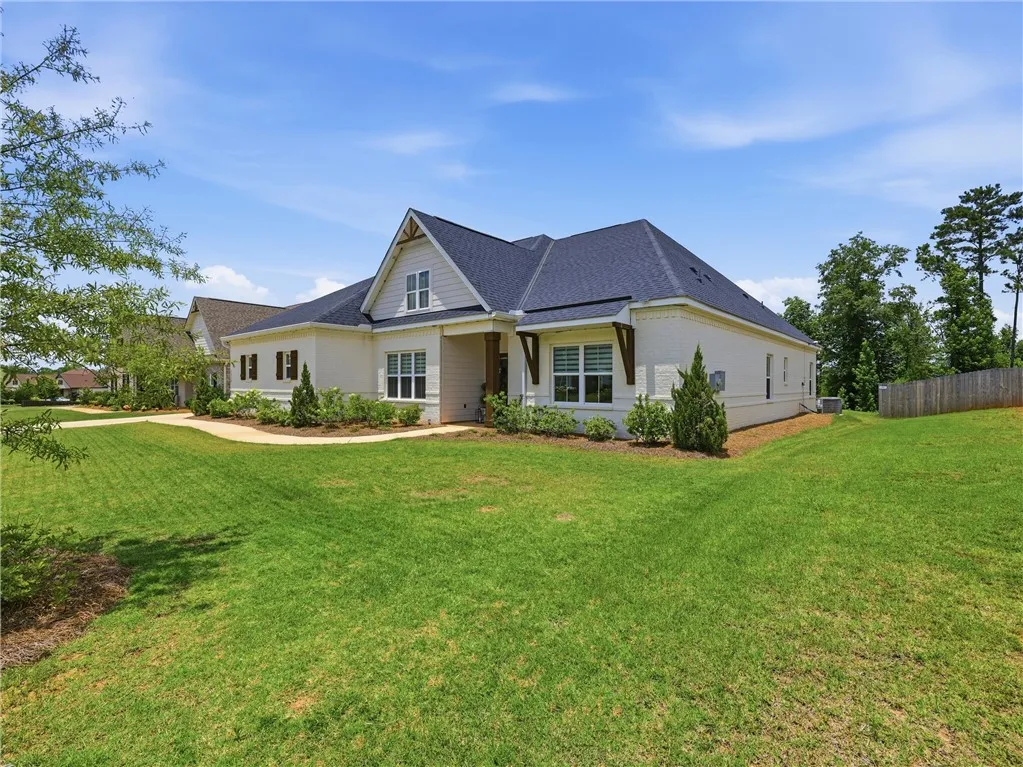 A classic facade with a charming porch and verdant lawn creates inviting curb appeal.