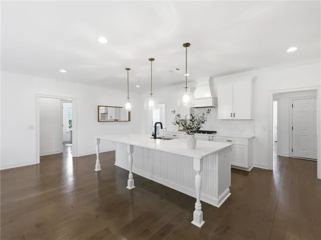 A spacious kitchen features a grand center island, ideal for entertaining and culinary creation.