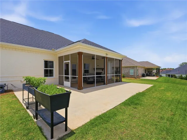 Enjoy outdoor living with a spacious screened-in porch and ample yard space.