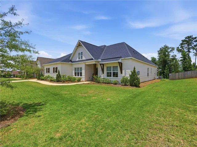 A classic facade with a charming porch and verdant lawn creates inviting curb appeal.