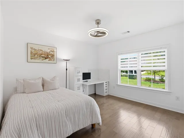Well-lit interior space with a window offering views of the outdoors, complemented by sleek flooring.