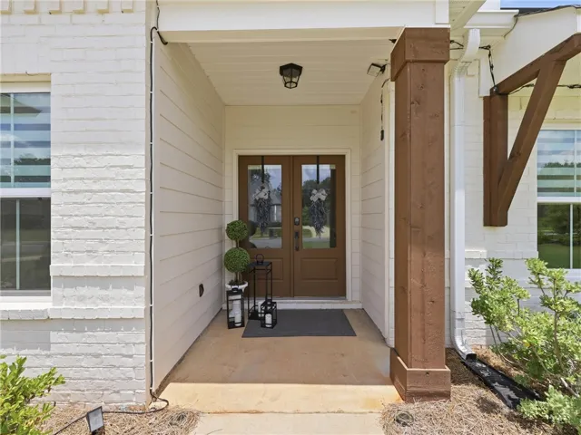 A welcoming front entry features double doors, inviting you into this charming home.