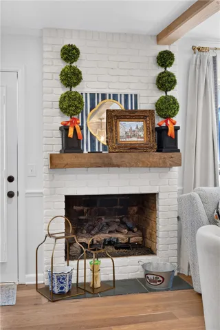A striking fireplace with a rustic wood mantel creates a cozy focal point.