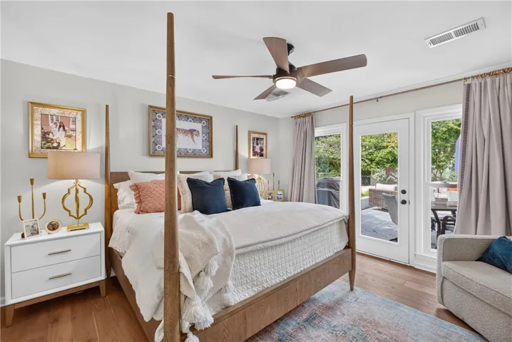 Elegant flooring grounds this primary suite with direct access to the outdoors.