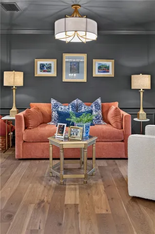 Rich flooring complements a striking living area featuring deep wall tones and sophisticated lighting.