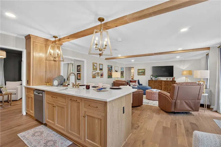 A grand kitchen island with a clean countertop anchors this inviting open-concept living space.