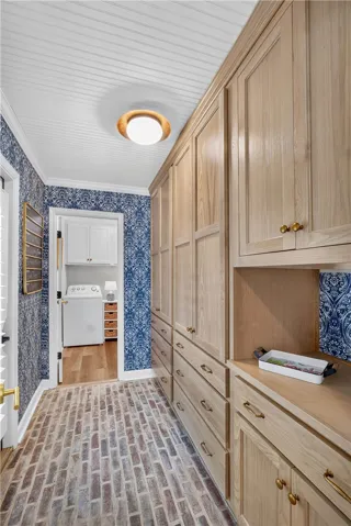 A clever laundry room with custom cabinetry provides smart utility and storage.
