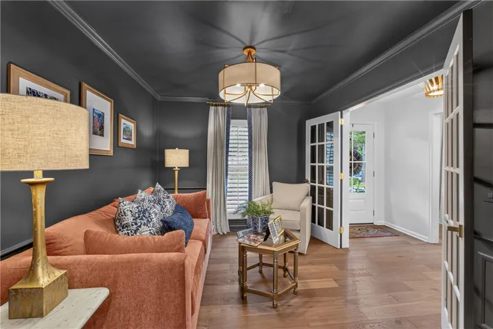 Wood floors and French doors lead into this inviting, sun-filled living space.